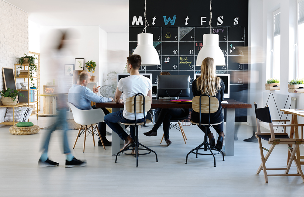 Professional Young Modern Office Young employees working at computers in modern office | SmartFee
